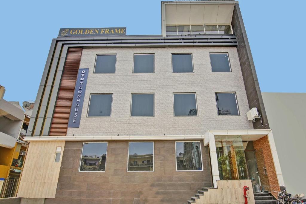 a building with a sign on the side of it at Townhouse Golden Frame near sec 62 noida in Ghaziabad