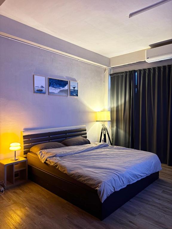 a bedroom with a large bed and two lamps at Mango Rooms & Rooftop in Bangkok