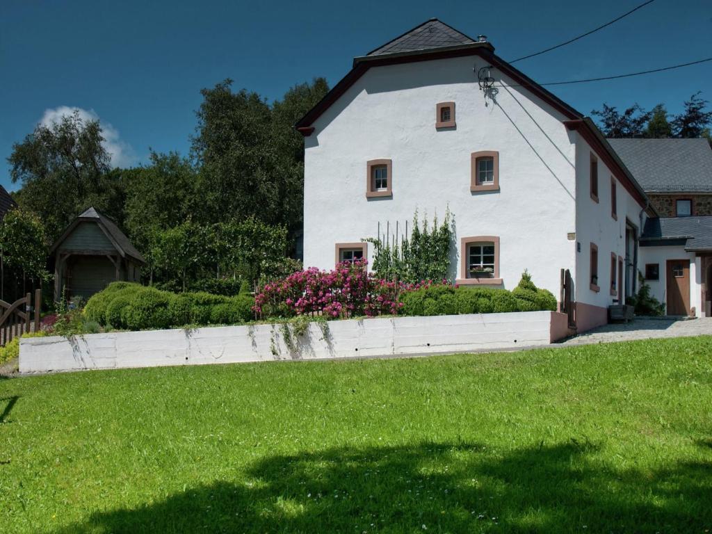 a large white house with a grass yard at Holiday Home in Bullange with Sauna in Bullange