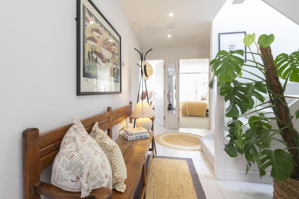 a living room with a couch and a plant at Contemporary 2-Bed 2-Bath Home with Parking in Cheltenham