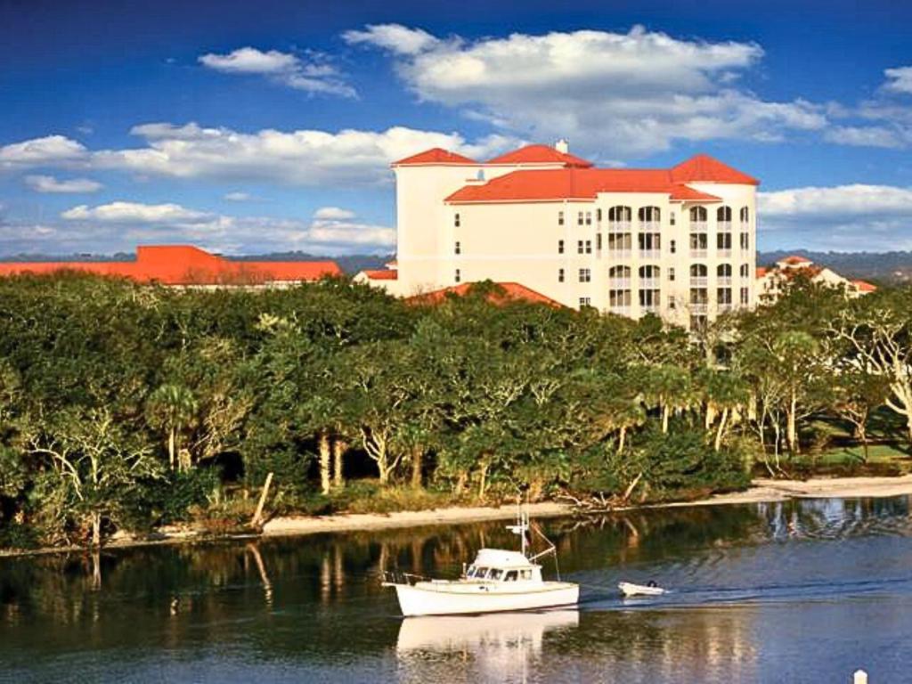 a boat in the water in front of a large building at Palm Coast Resort 109 in Palm Coast