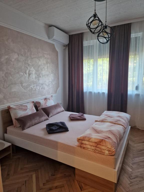 a large bed in a room with a large window at Z - apartment 2 in Tryavna