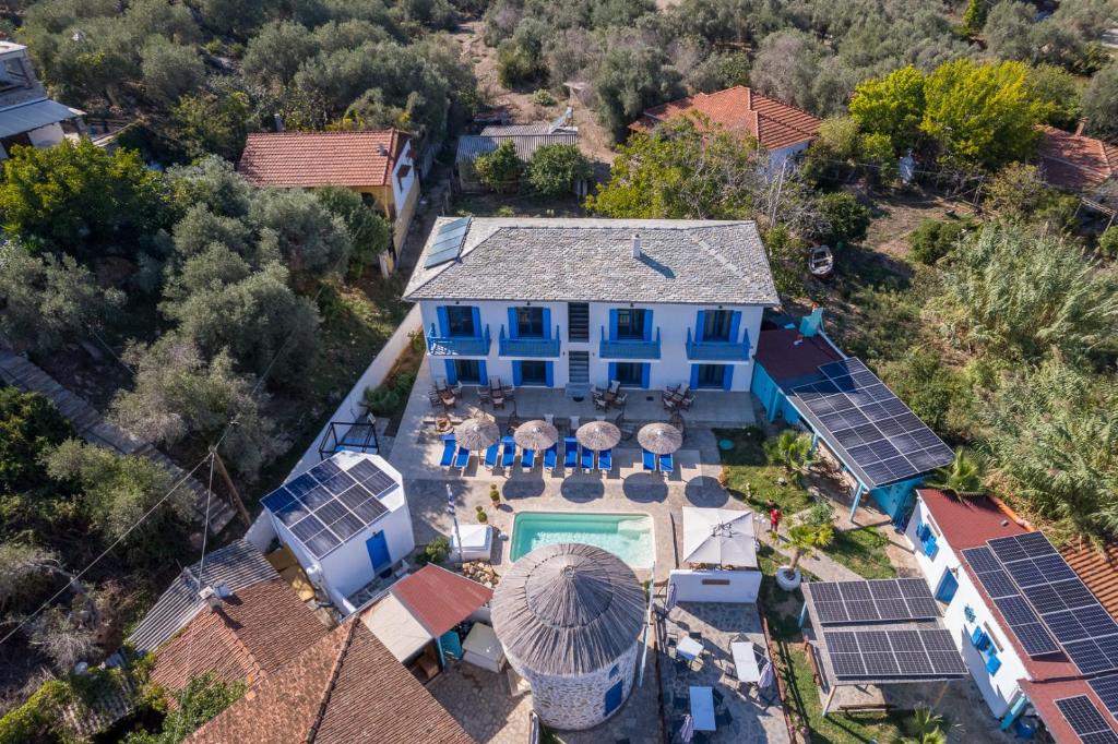 an aerial view of a blue house with solar panels at Katigiorgis Blue Hotel & Bungalow SPA Resort in Agios Georgios