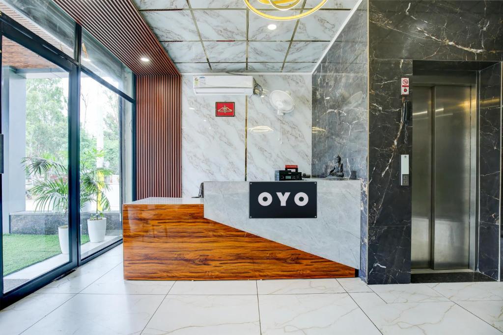 an office lobby with aype sign on a reception desk at Hotel O Platinum in Zirakpur