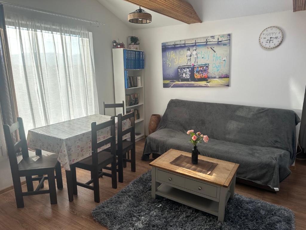 a living room with a couch and a table at Aqua Garden Junior Miercurea Ciuc in Miercurea-Ciuc