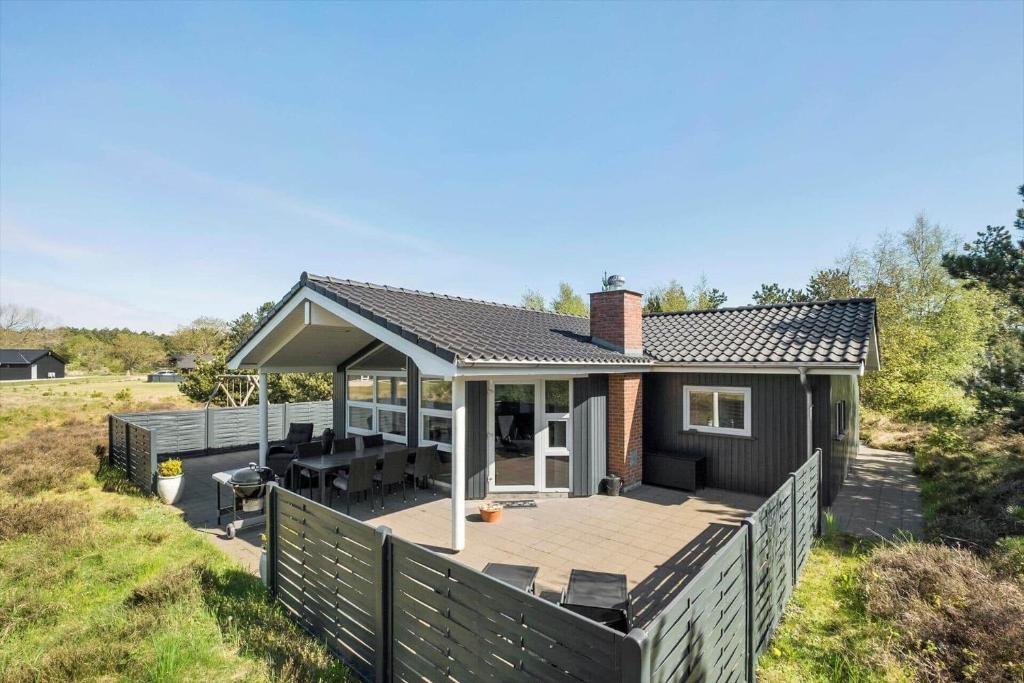 a house with a deck and a patio at 0403-Romo-Lyngvejen-44-C in Høm