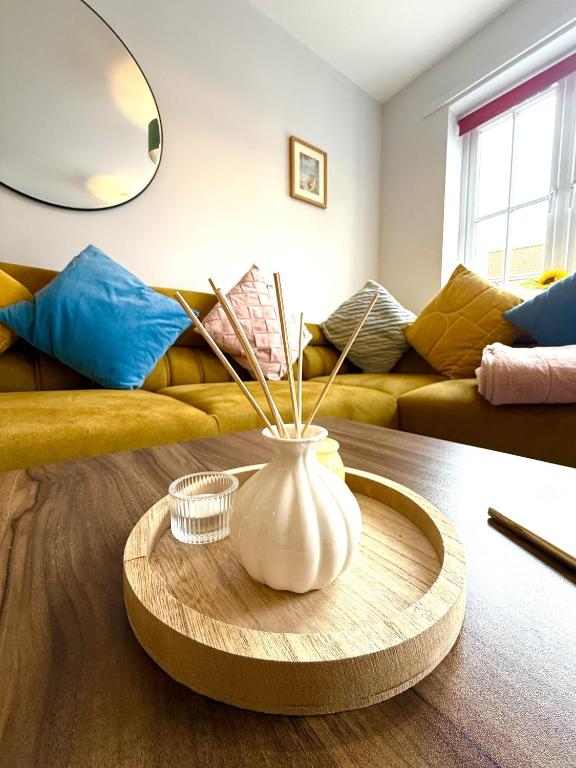 a living room with a vase on a coffee table at Jambow Blue in Filey