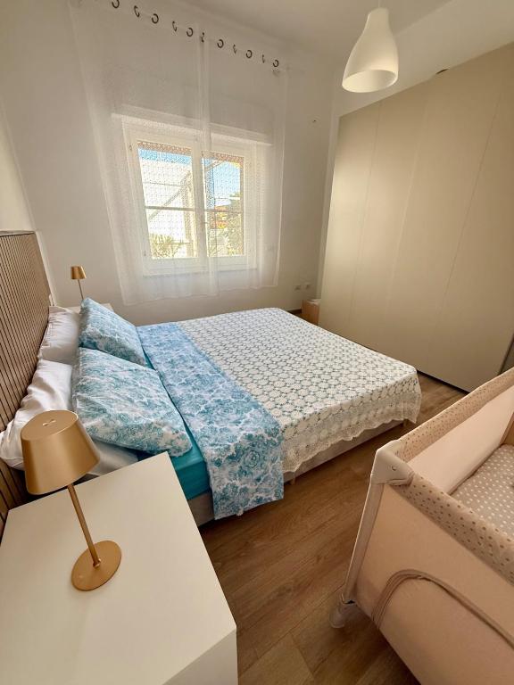 a bedroom with two beds and a table and a couch at Casa Rosmarino in Carbonia