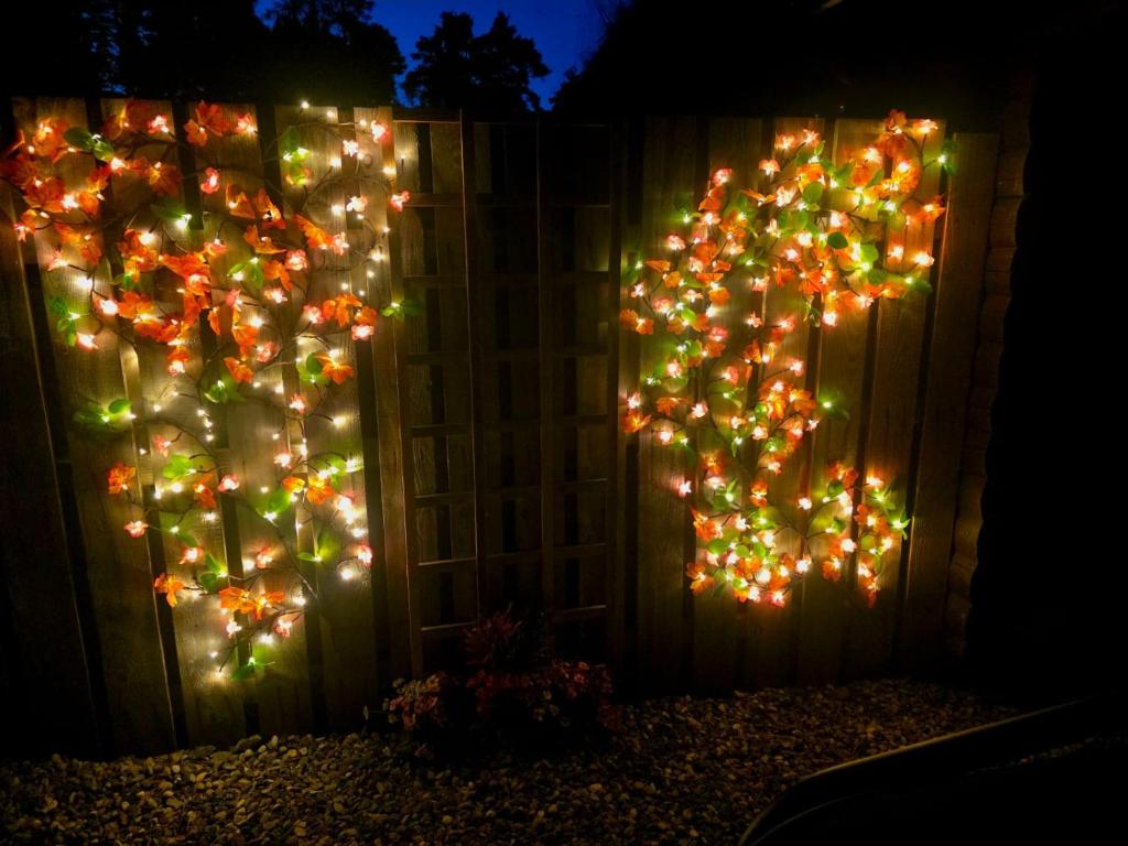 a fence with christmas lights on it at Kaoglen-Blossom-Hot tub-Cairngorms-Pet Friendly in Balnald