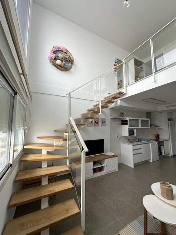 a staircase in a living room with a kitchen at Beach House Renata in Gran Alacant
