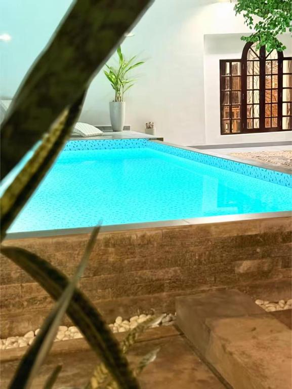a large blue swimming pool in a house at Navis villa in Galle