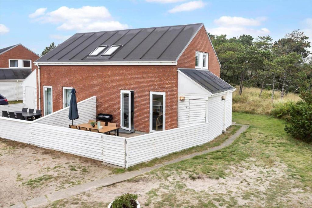a red and white house with a black roof at 0442-Romo-Vestergade-137-Ap-101 in Høm
