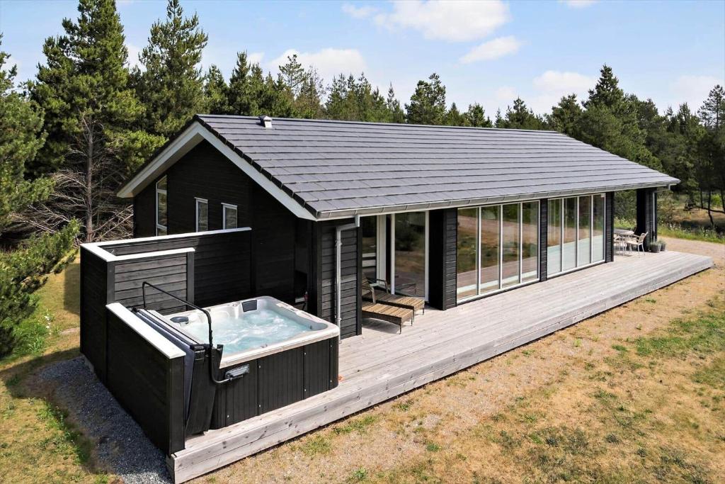 a house with a hot tub on a deck at 0122-Romo-Smafolksvej-44 in Høm