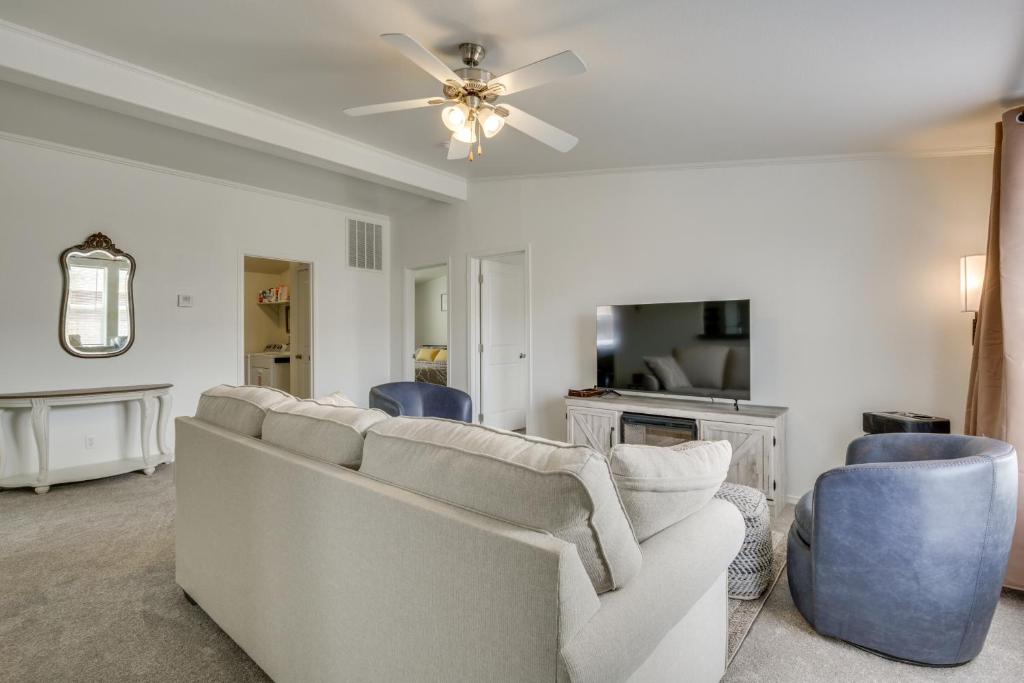 a living room with a white couch and blue chairs at 1 Mi to Main Street Cozy Retreat in Portales in Portales