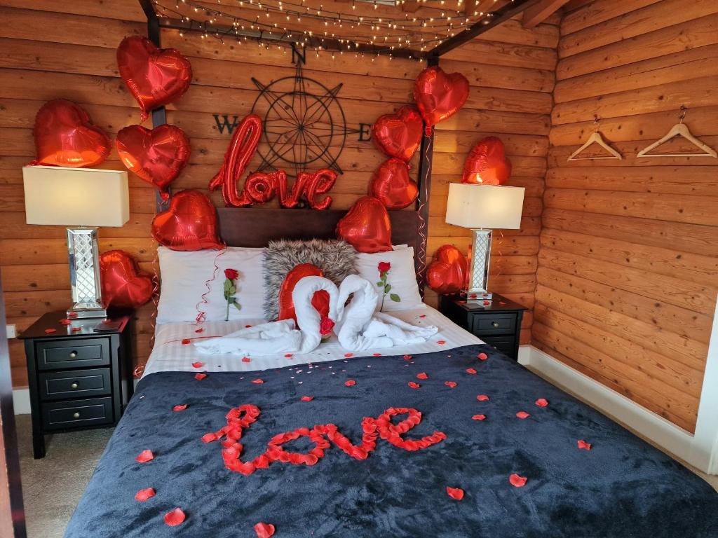 a bedroom with a bed with love written on it at Kaoglen-Stags-Hot tub-Cairngorms-Pet Friendly in Balnald