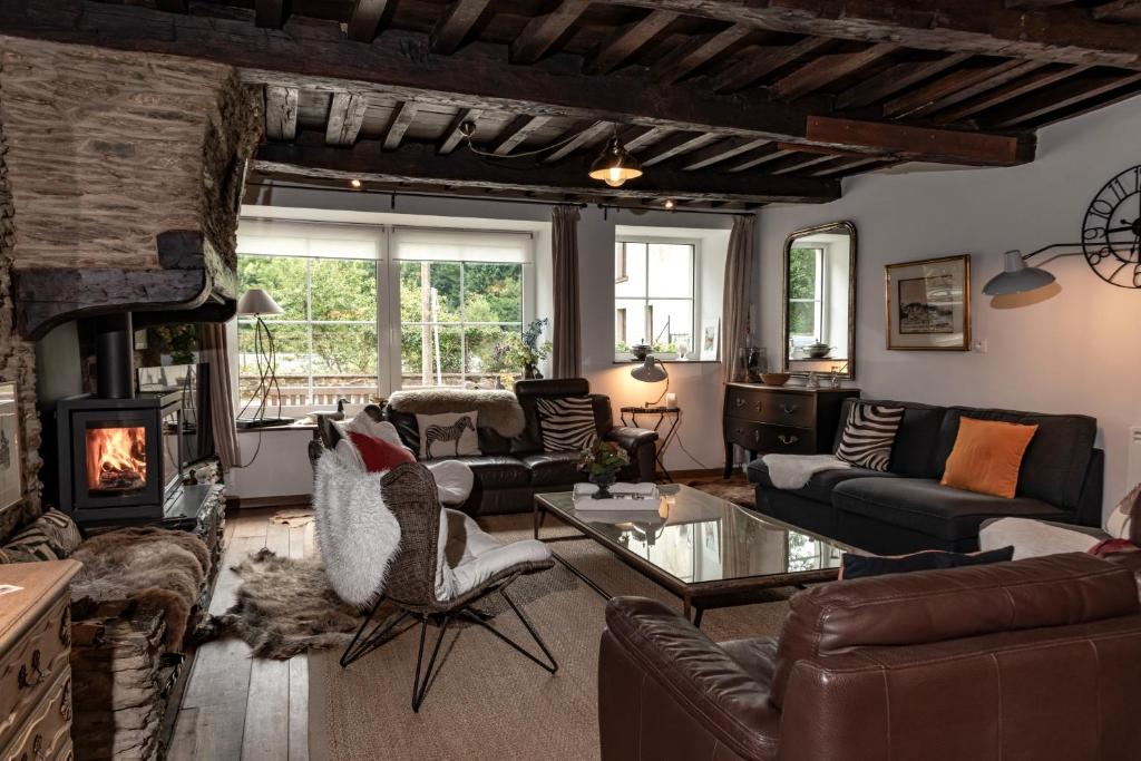 a living room filled with furniture and a fireplace at Au 13 du Faubourg de France à Bouillon, un cocon plein de charme in Bouillon