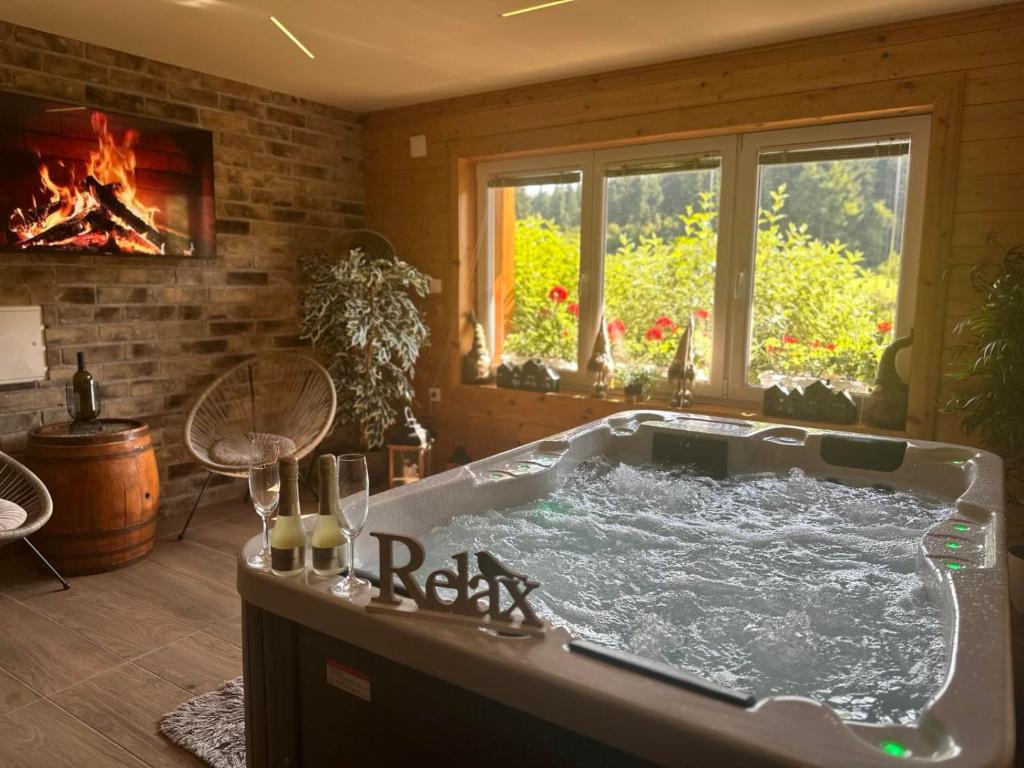 a bath tub in a room with a fireplace at Holiday Home Lino in Brod Moravice