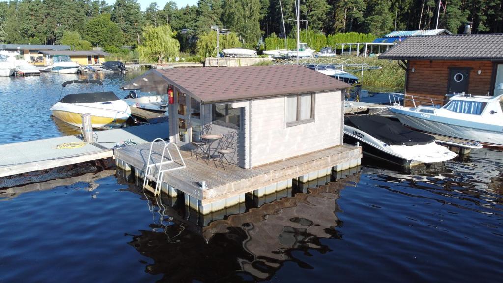 a small house on a dock in the water at Floating Camp House in Jūrmala