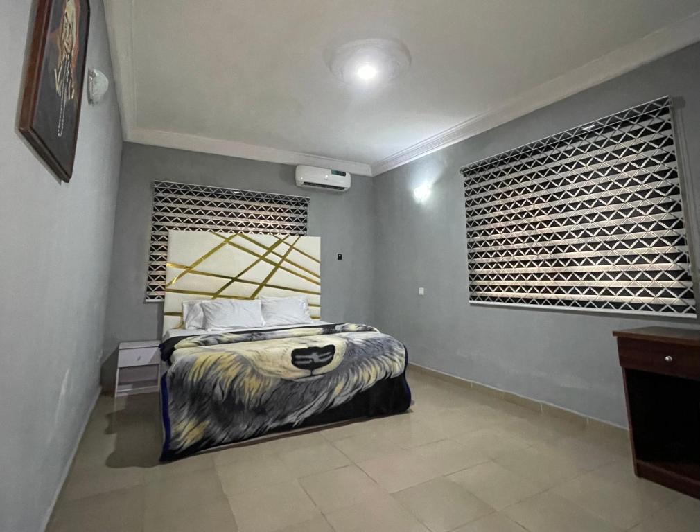 a bedroom with a bed and a large window at Ungess Global Ventures in Iju Junction