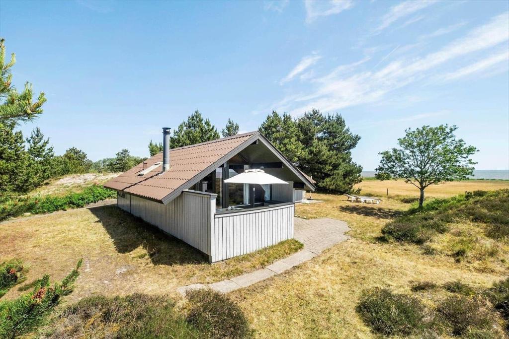 a small cabin in a field with a roof at 0231-Romo-A-M-Listsvej-8 in Tagholm
