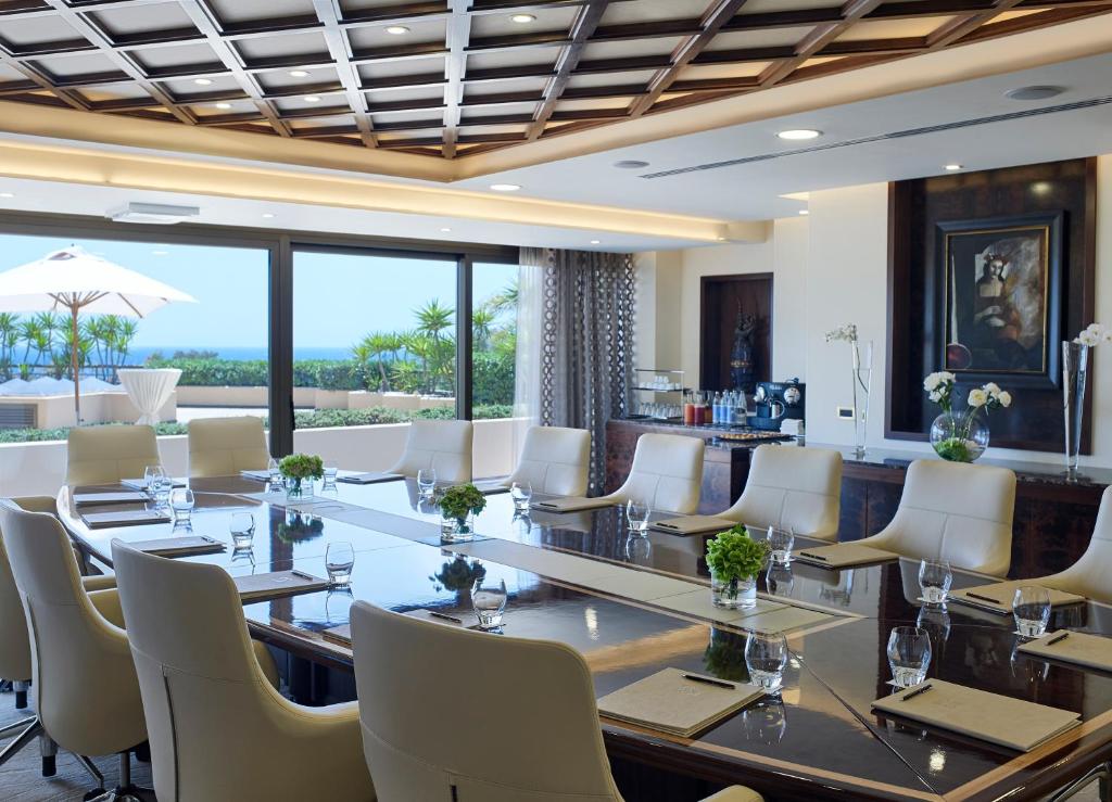 a conference room with a long table and white chairs at Four Seasons Hotel in Limassol