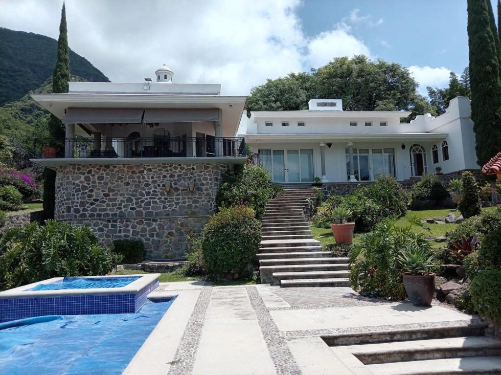 a house with a swimming pool in front of it at Casa Vinca in San Juan Cosalá