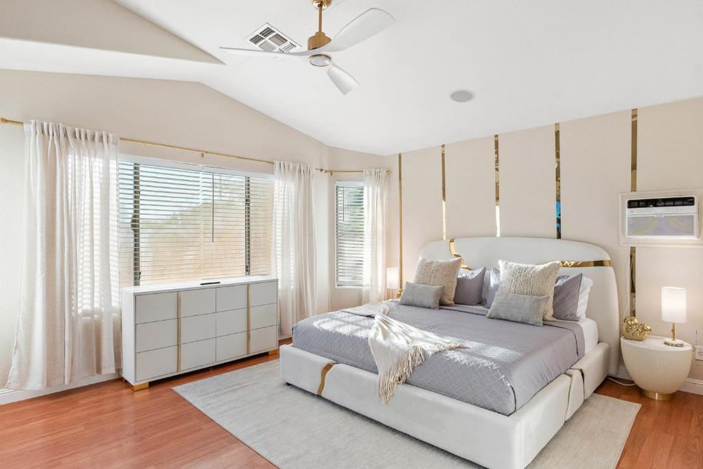 a bedroom with a bed and a ceiling fan at Reset Rally Pool Hot Tub Firepit in Casa Grande