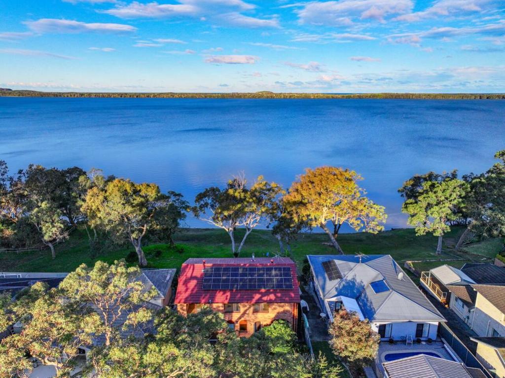 an aerial view of a house with a view of a lake at Lakefront Peace and Relaxation in Budgewoi
