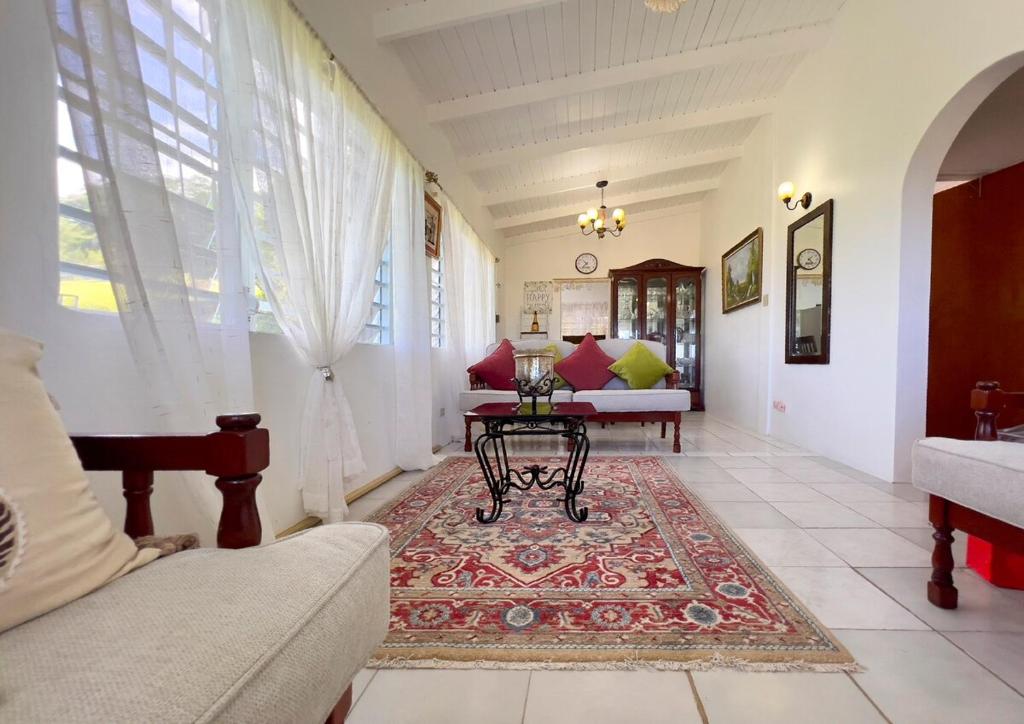 a living room with a couch and a table at Tropical Retreat in Matthews