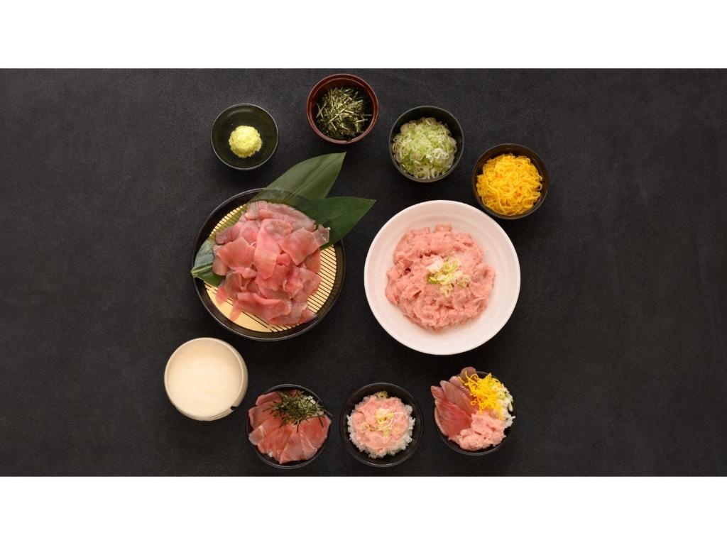 a group of bowls of food on a table at Smile Hotel Kanazawa Nishiguchi Ekimae - Vacation STAY 24214v in Kanazawa