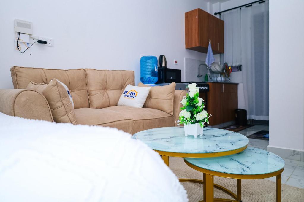a living room with a couch and a table at Cozy & private studio in Membley Ruiru Nairobi Kenya in Ruiru