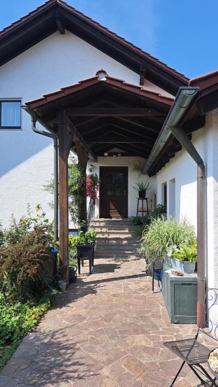 a wooden pergola on the side of a house at Familie Pöllet in Stammham