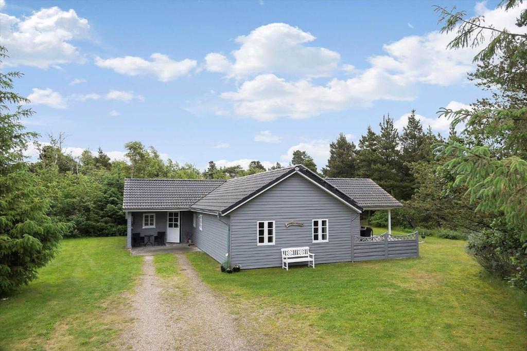 a small grey house with a grass yard at 0130-Romo-Ejnar-Mikkelsensvej-22 in Kongsmark