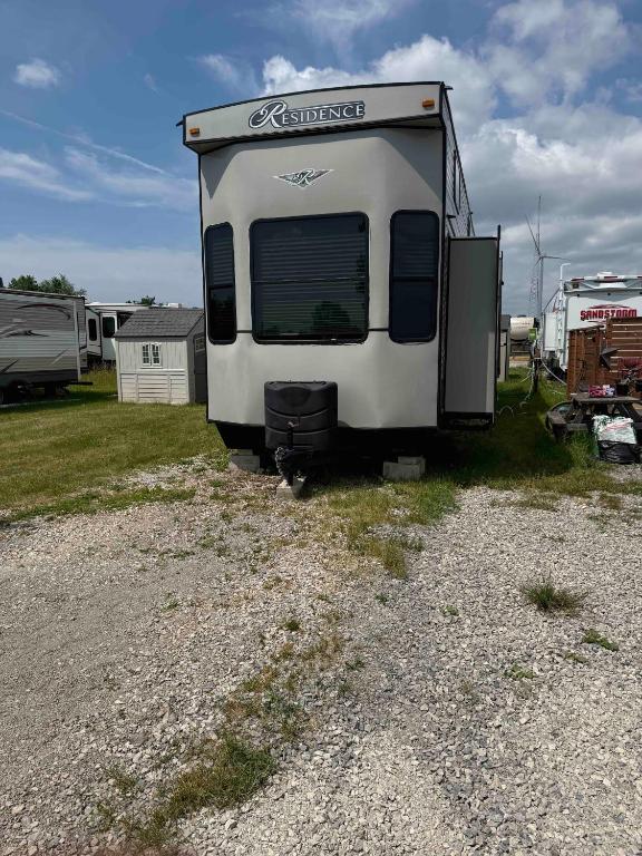 a camper is parked in a gravel lot at Maitland Shires Resort in Port Maitland