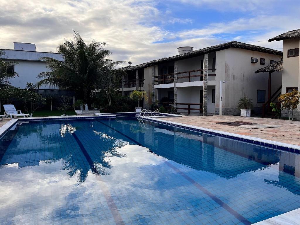 ein großes Schwimmbad vor einem Gebäude in der Unterkunft Condomínio Ouro – Piscina e Praia a Poucos Passos in Porto Seguro