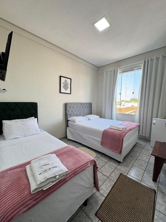 Ένα ή περισσότερα κρεβάτια σε δωμάτιο στο Apartamento privativo Good Vibes na região central