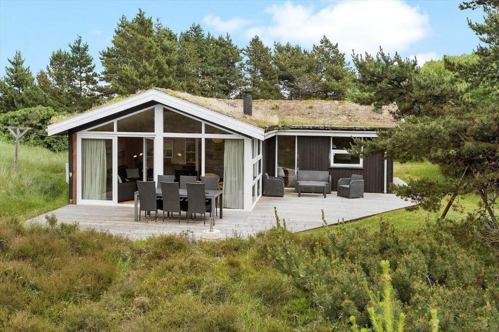 a pavilion with a deck in the middle of a field at 0021-Romo-Ringvejen-74 in Høm