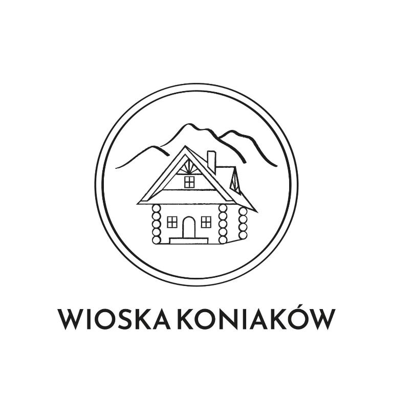 a logotype of a house in a circle with mountains at Wioska Koniaków in Koniaków