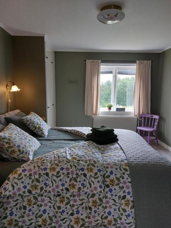 a bedroom with two beds and a window at Woxy Lilaloppan - privacy, space and nature in Voxnabruk