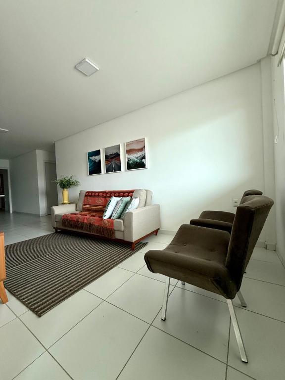 a living room with a couch and a chair at Edificio Artur Regis in Petrolina