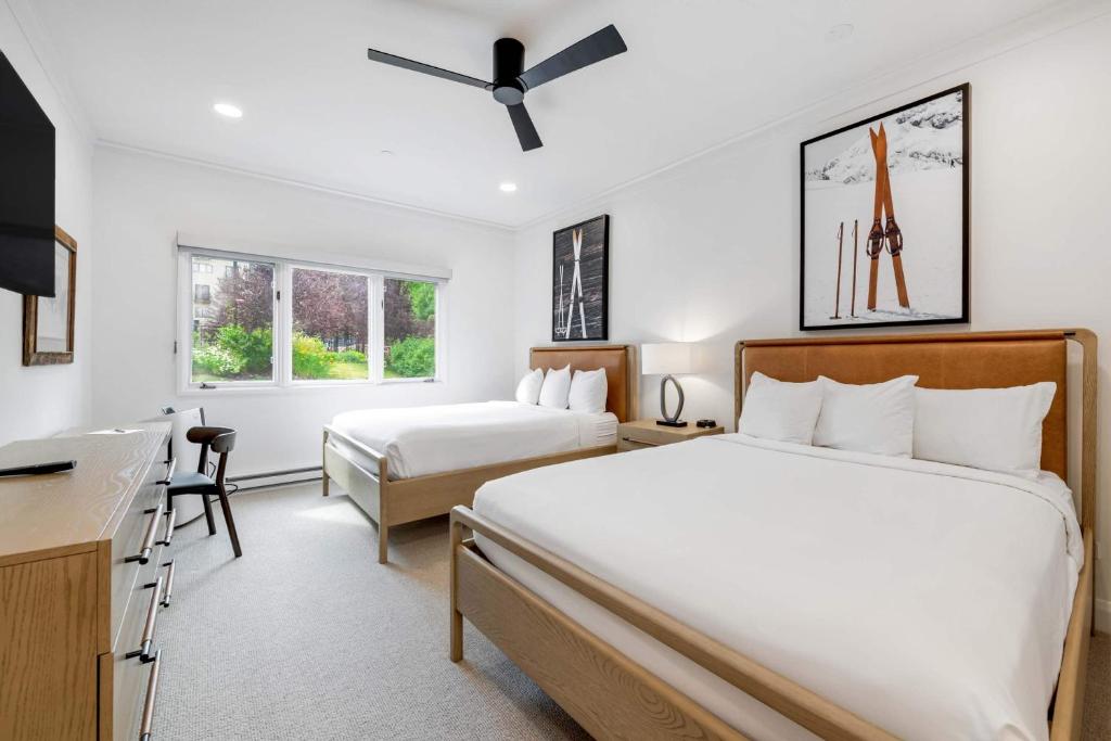 a hotel room with two beds and a desk at The Charter at Beaver Creek E135 in Beaver Creek