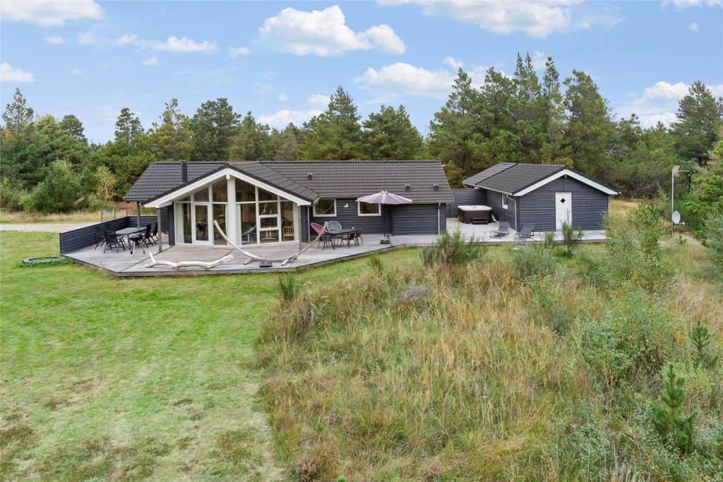 a home with a large deck and a house at 0195-Romo-Smafolksvej-65 in Kongsmark