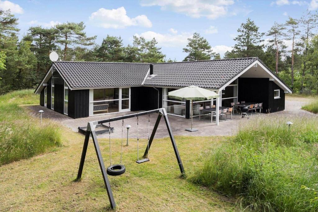 a house with a playground in front of it at 0317-Romo-Sonderstrandvej-24 in Høm