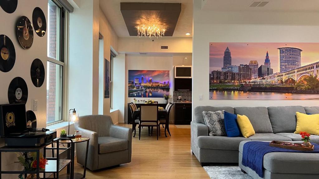 a living room with a couch and a dining room at Downtown Cleveland- Steps to Sports & Events condo in Cleveland