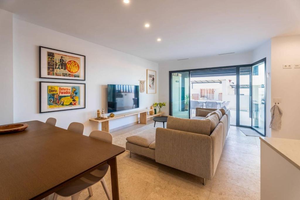a living room with a couch and a table at Luxury House in El Mirador Calaceite Torrox Costa, Hus 19 in Torrox Costa