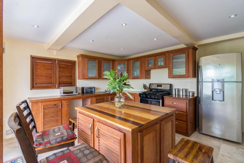 a kitchen with wooden cabinets and a stainless steel refrigerator at Sandrati Villa in Port Elizabeth