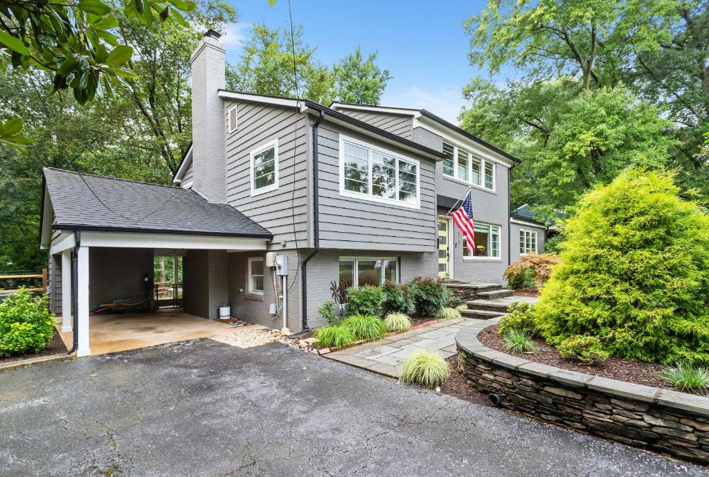 a house with an american flag in the driveway at Sojourn Beautiful Family Home with Beach Access & Backyard in Falls Church
