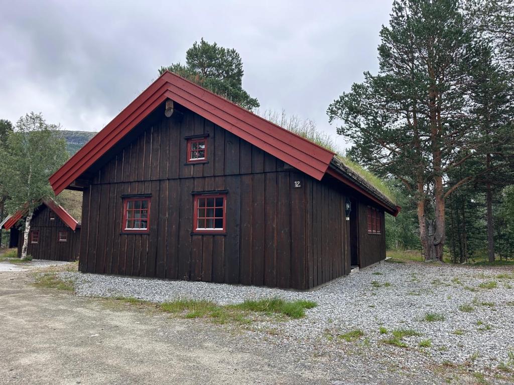 a brown building with a red roof and windows at Bjorliheimen Fjellhotell-Hytte 11 & 12 in Bjorli