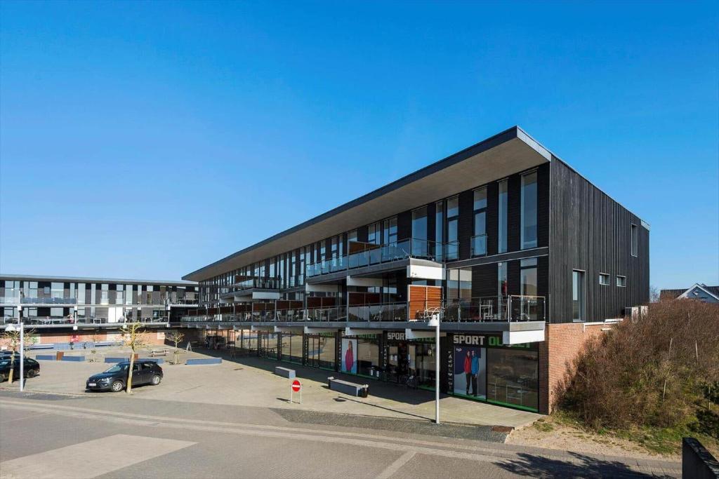 a large black building with a parking lot at 0274-Romo-Nordre-Havnevej-42 in Havneby