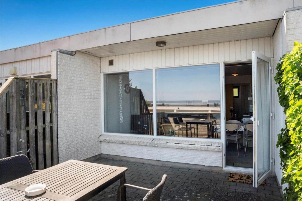 a patio with a table and a view of the ocean at 0265-Romo-Lyngvejen-99-Ap-18 in Høm